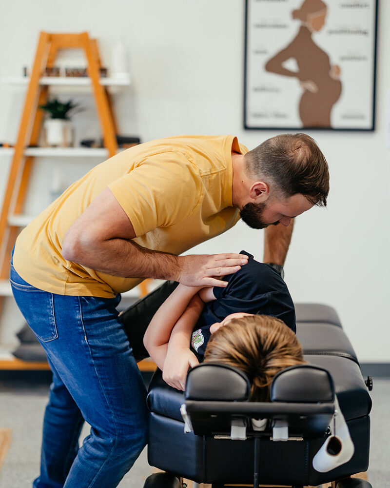Chiropractor adjusting patient on a table to support the vagus nerve